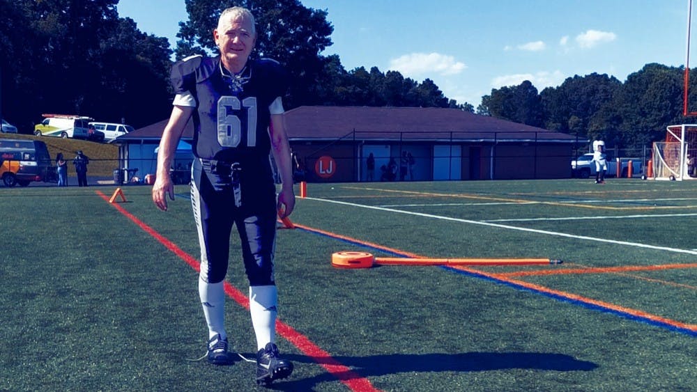 His teammates revere Lynch as a team mascot, an accomplished 61-year-old professor who is able to keep up with their exercises and help the team by scoring extra points. &nbsp;
