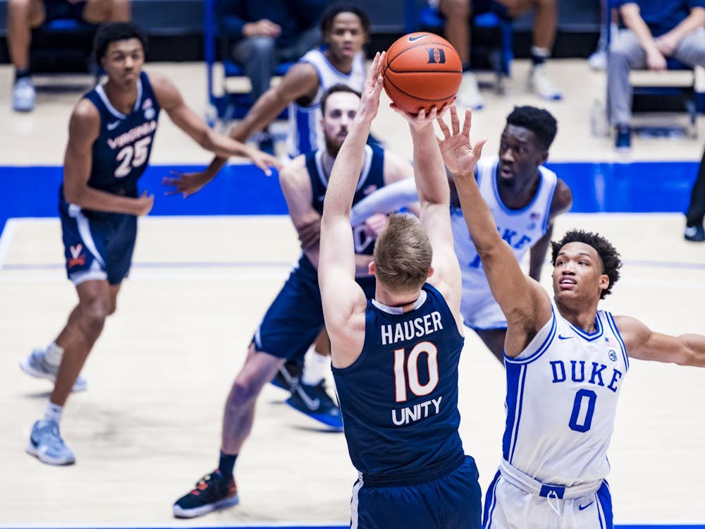 Virginia senior forward Sam Hauser shoots over Duke sophomore forward Wendell Moore.