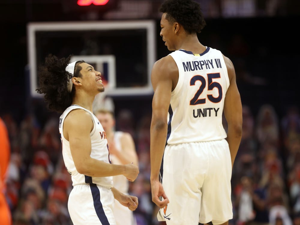 Virginia junior guards Trey Murphy and Kihei Clark celebrate a play during the game