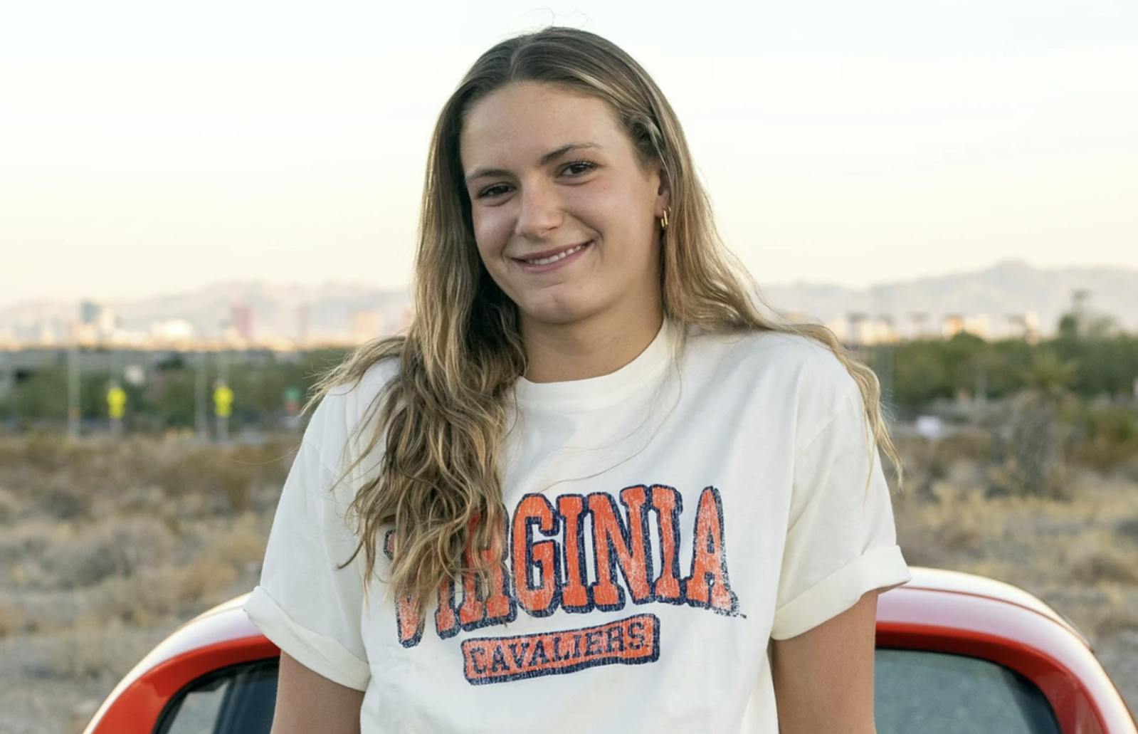 Grimes poses in a Virginia shirt for her announcement.