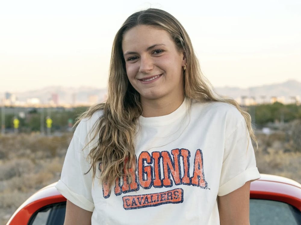 Grimes poses in a Virginia shirt for her announcement.