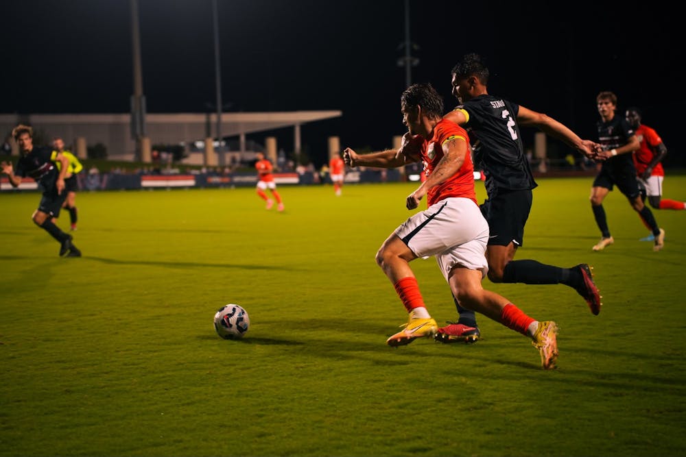 <p>Junior midfielder Albin Gashi battles with a Stanford defender Sept. 27.</p>