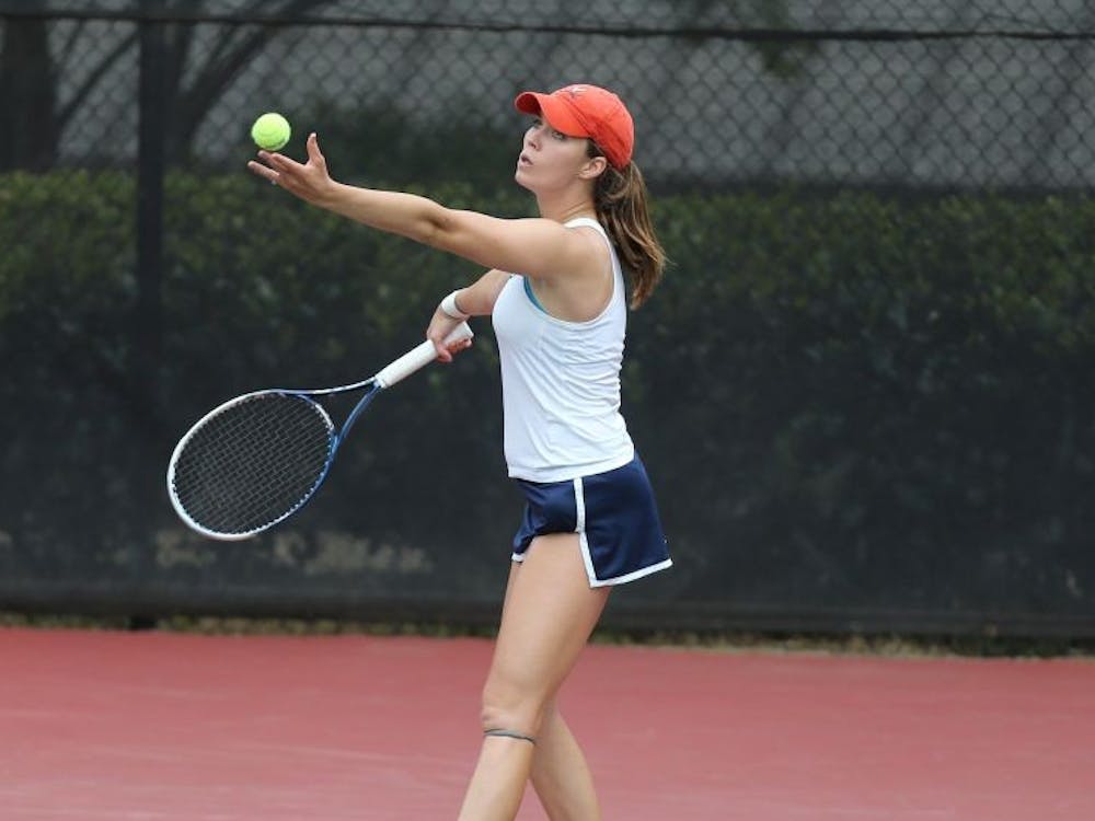 Collins prepares to serve during a 2014 sophomore campaign that would lead to the first of her two NCAA singles titles.