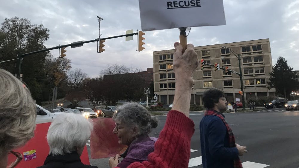 Hundreds of protesters gathered along the sidewalk in front of the Albemarle County Office Building, many holding signs expressing their opposition to appointment of Matthew Whitaker of Acting Attorney General.