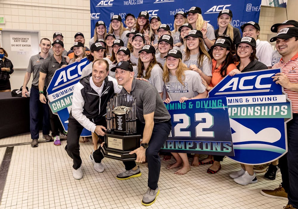 <p>Coach Todd DeSorbo celebrates with the women's team as they take home their third straight ACC Championship trophy.</p>