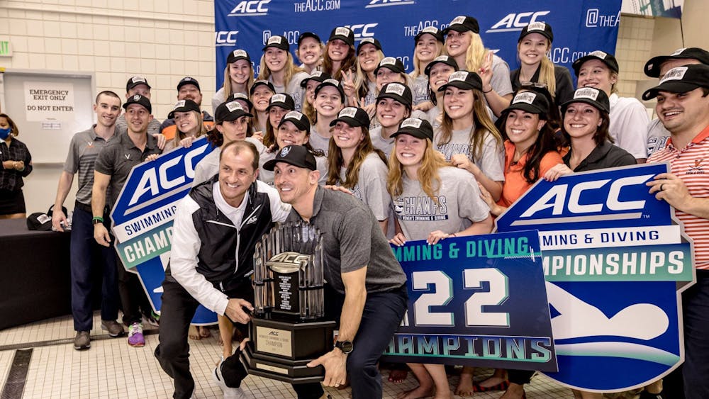 Coach Todd DeSorbo celebrates with the women's team as they take home their third straight ACC Championship trophy.