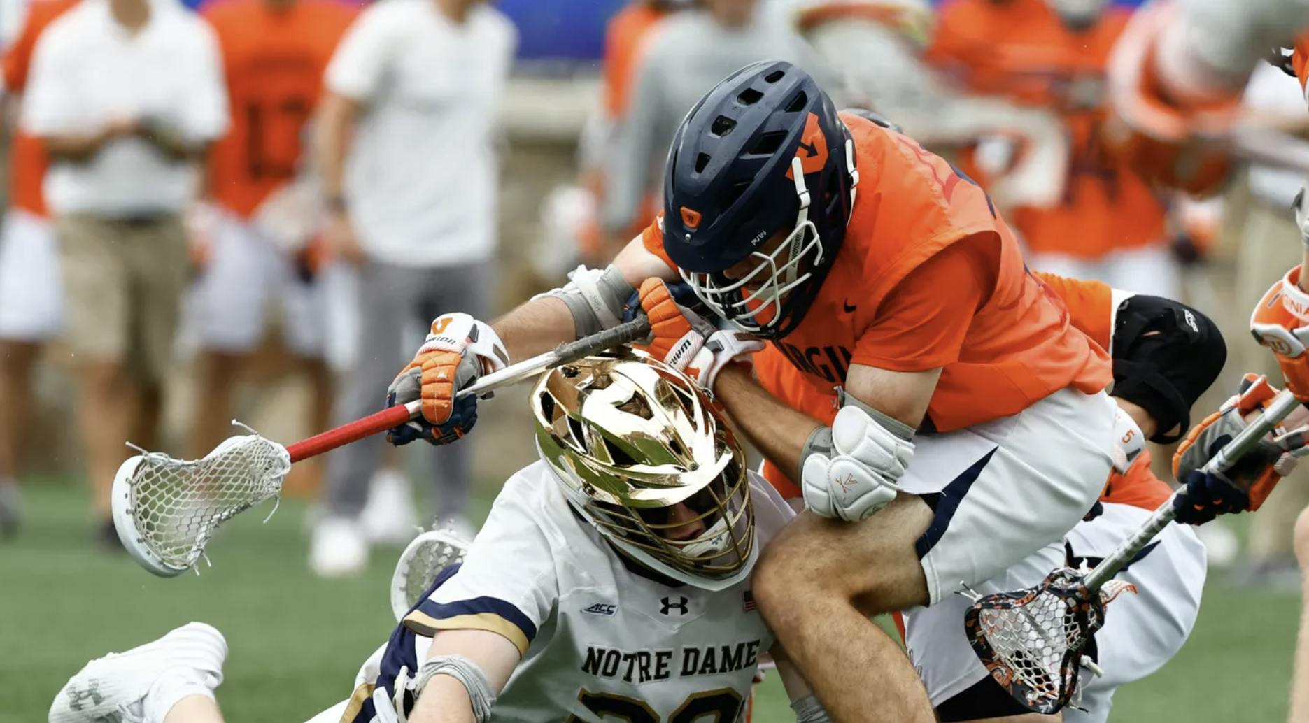 Players wrestle for a ground ball.