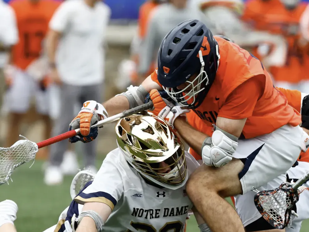 Players wrestle for a ground ball.