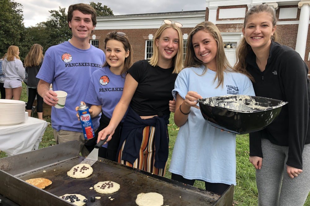 <p>Volunteers at Pancakes for Parkinson's pose for a picture on the South Lawn Saturday while making pancakes.&nbsp;</p>