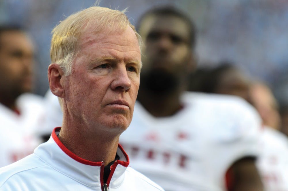 N.C. State football head coach Tom O'Brien reflects upon the Wolfpack's first loss to UNC-Chapel Hill under his leadership as the Power Sound of the South plays the alma mater after the game in Kenan Stadium Saturday, Oct. 27, 2012. Photo by John Joyner.