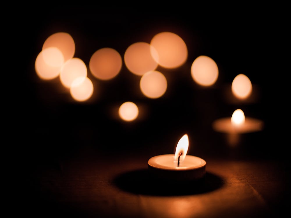 The lights were dimmed to near darkness and each of the women possessed a candle in hand. 