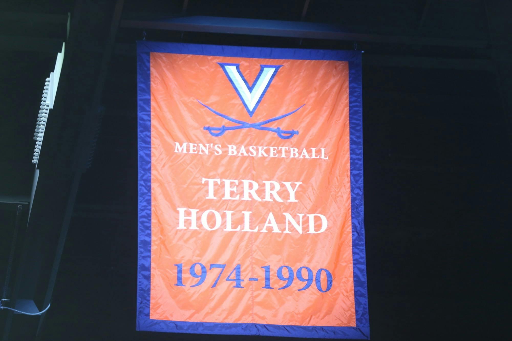 Athletic Director Carla Williams unveiled a banner commemorating Holland's achievements and impact on Virginia basketball Saturday.