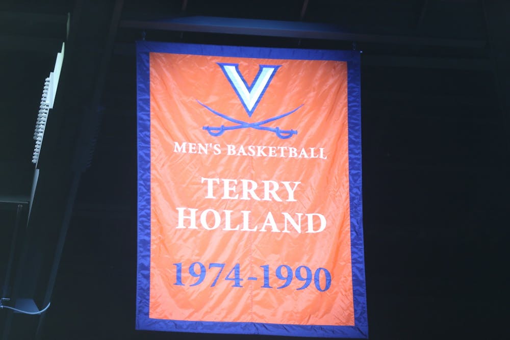 <p>Athletic Director Carla Williams unveiled a banner commemorating Holland's achievements and impact on Virginia basketball Saturday.</p>