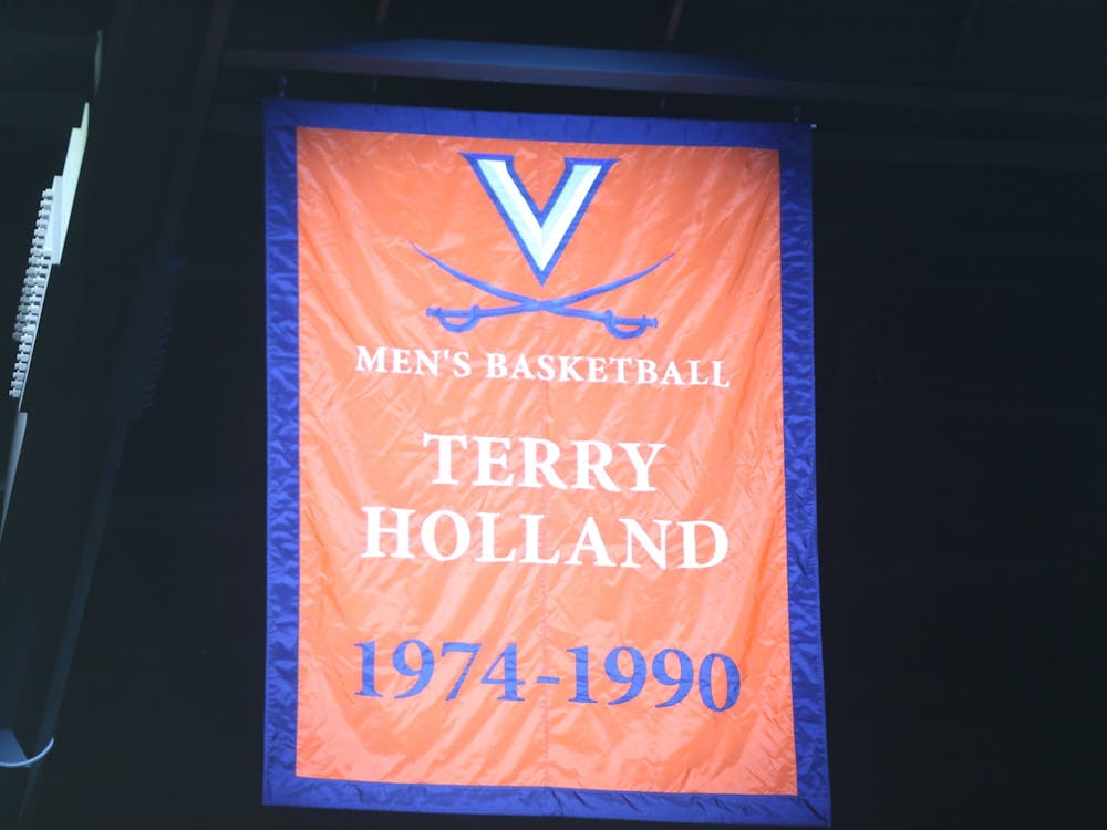 Athletic Director Carla Williams unveiled a banner commemorating Holland's achievements and impact on Virginia basketball Saturday.