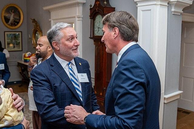 Republican lieutenant governor candidate John Reid speaks with Gov. Glenn Youngkin at the meeting of his LGBTQ+ Advisory Board June. 25, 2025.