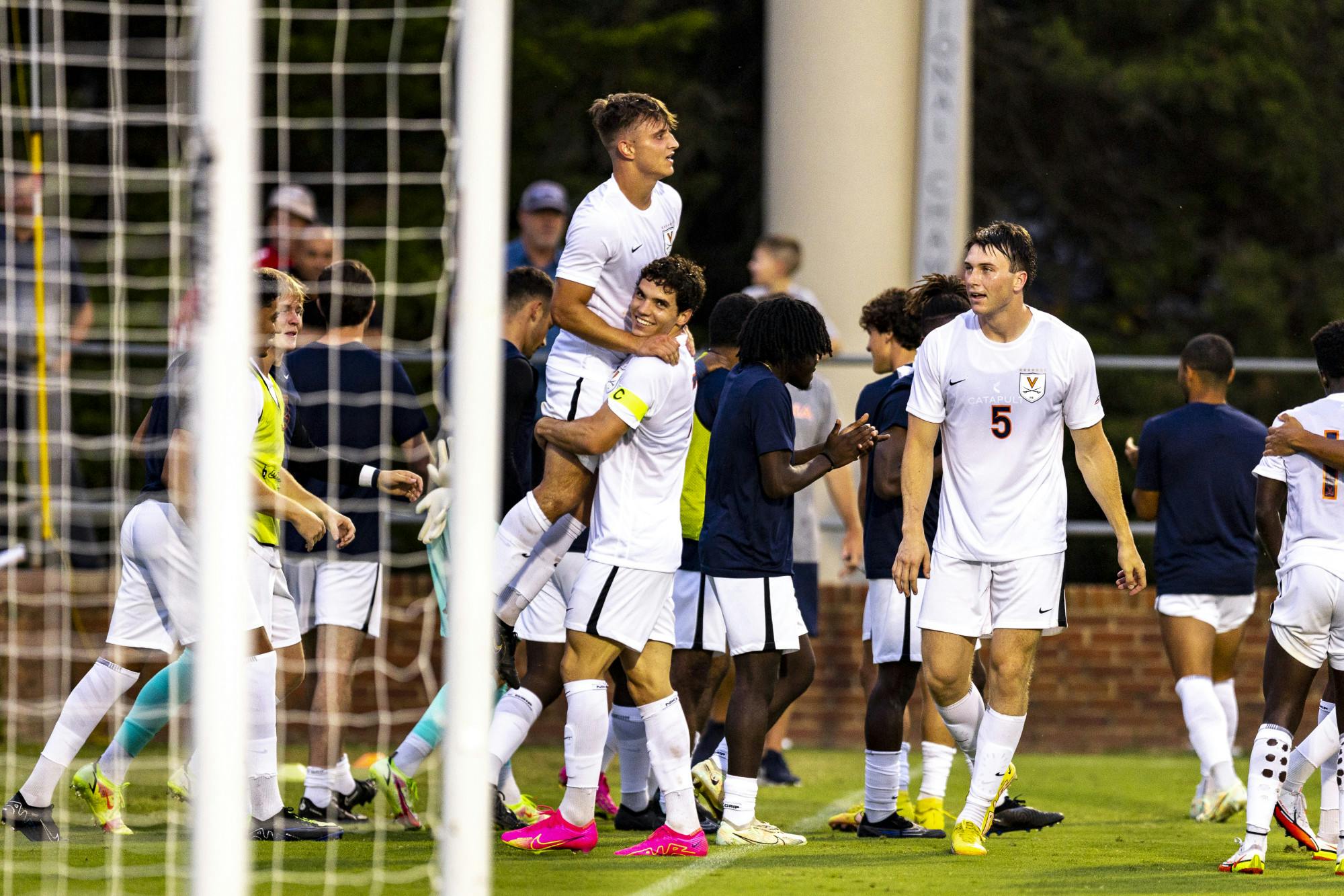 Senior midfielder Daniel Mangarov celebrates after scoring the winning goal for the Cavaliers .