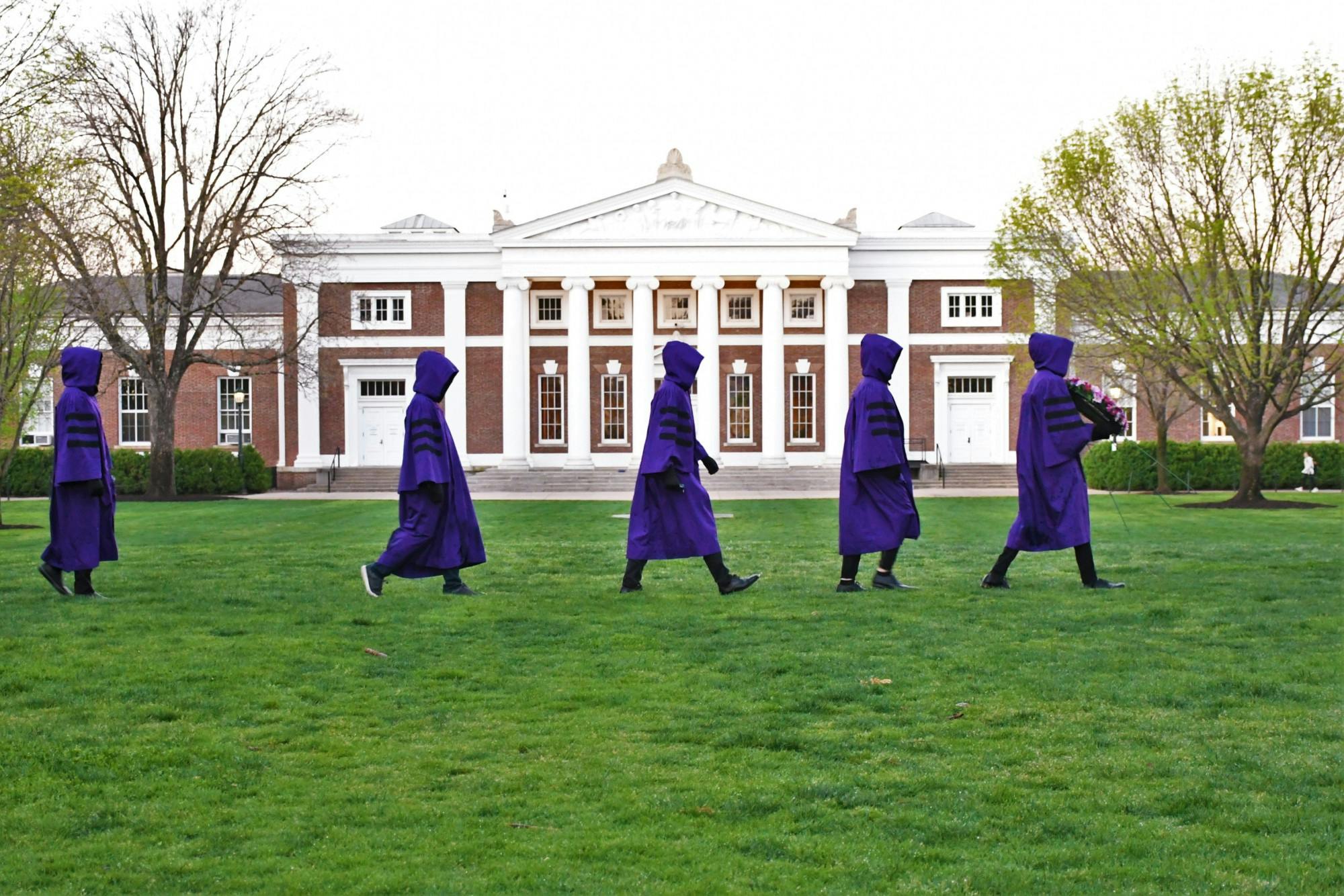 At sunrise, purple-robed members of the Society of Purple Shadows walked silently to the seated Jefferson statue on the South Lawn.