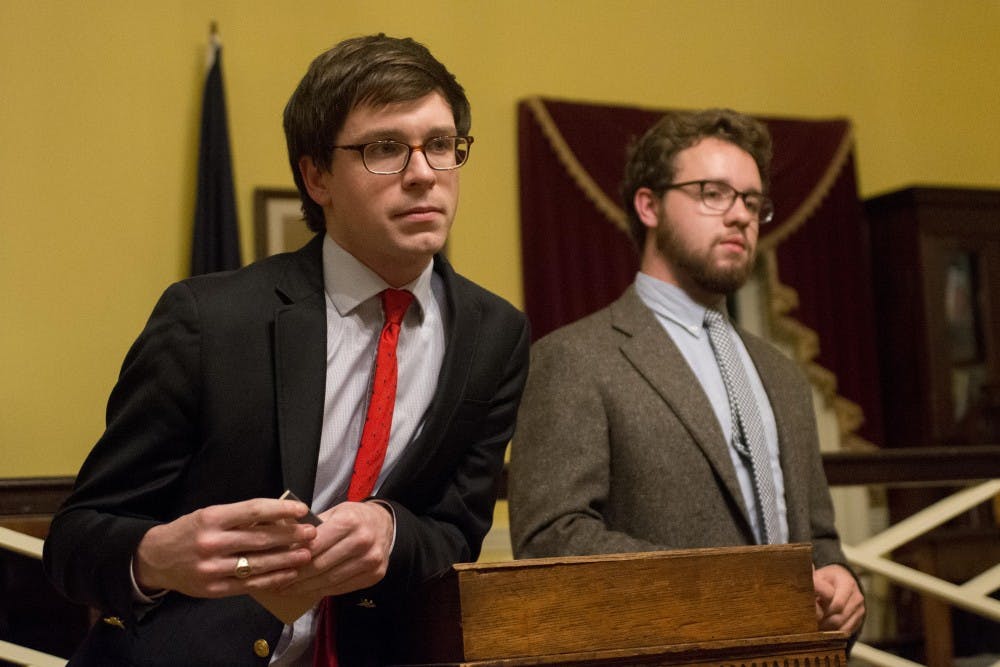 <p>Honor Committee representatives Owen Gallogly, left, and Jeffrey Warren, right, debate the single sanction system in Jefferson Hall.</p>