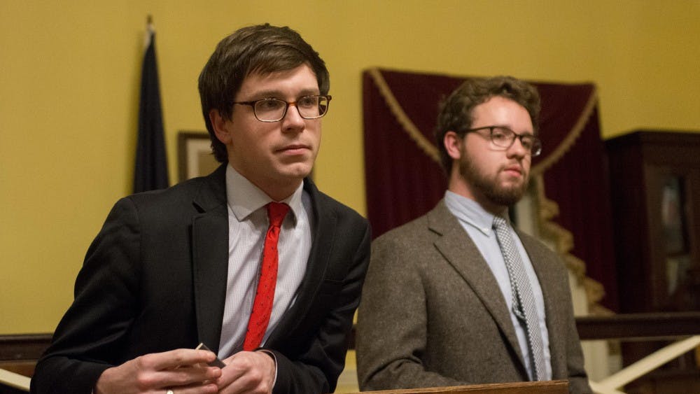 Honor Committee representatives Owen Gallogly, left, and Jeffrey Warren, right, debate the single sanction system in Jefferson Hall.