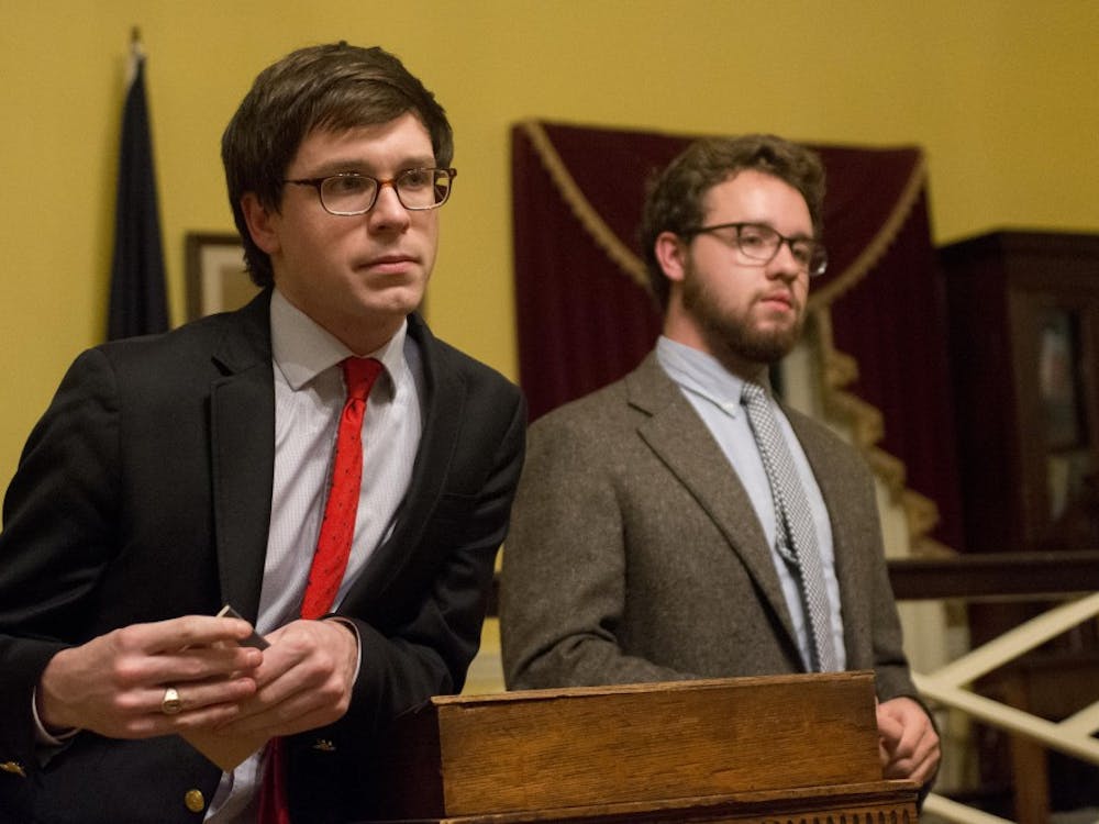 Honor Committee representatives Owen Gallogly, left, and Jeffrey Warren, right, debate the single sanction system in Jefferson Hall.