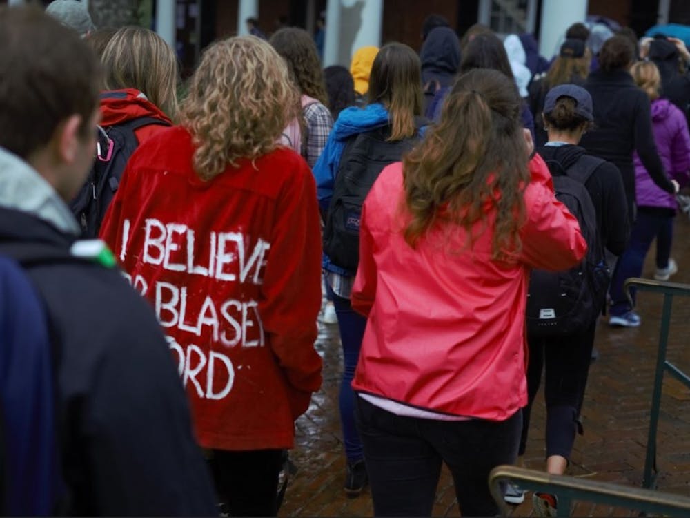 An attendee at the march wears a jacket reading "I believe Dr. Blasley Ford."&nbsp;