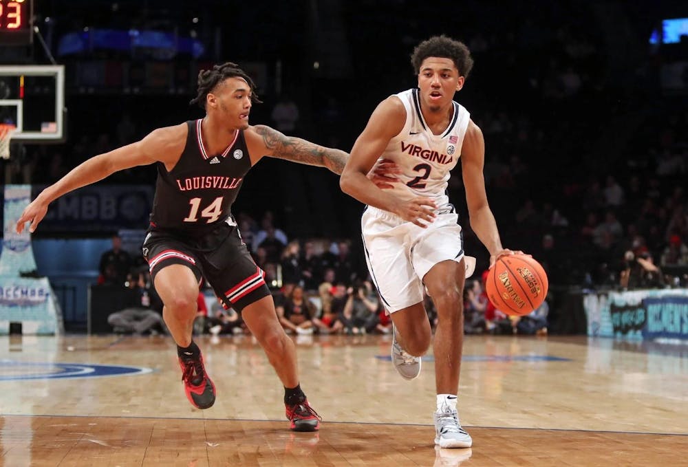 <p>Reece Beekman drives against a Louisville defender.</p>