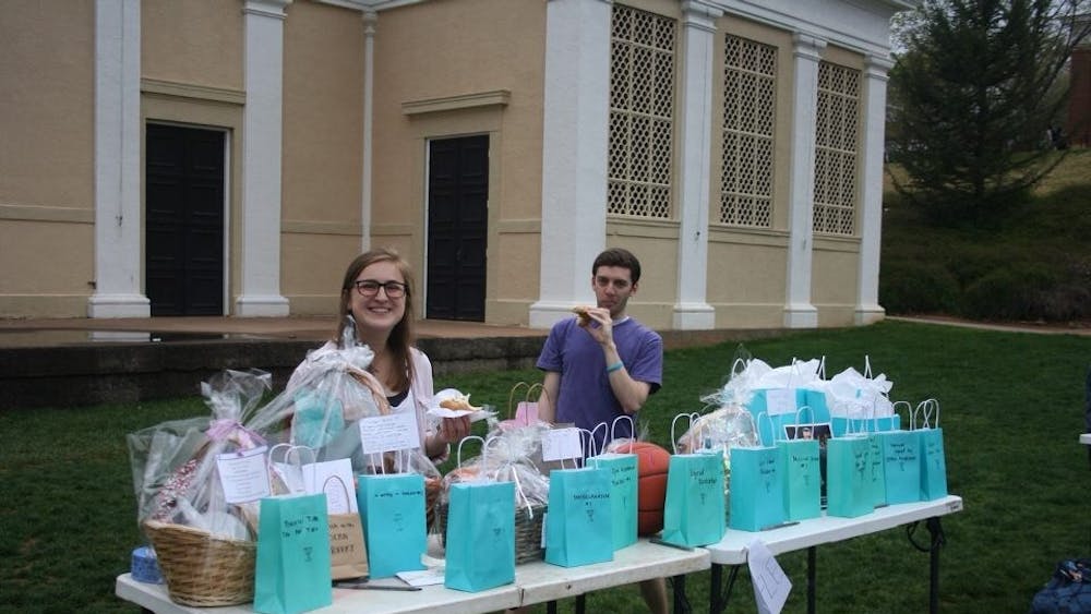 Kennedy Couch (left), a fourth-year College student and member of the Day of Healing committee, staffed the raffle table and helped pass out raffle tickets to students.&nbsp;