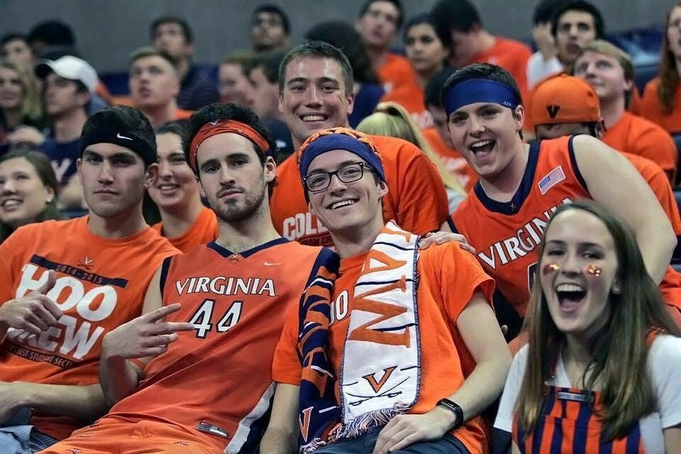 Dustin Jones (pictured second from left) sports his traditional gameday outfit with other Hoo Crew members.