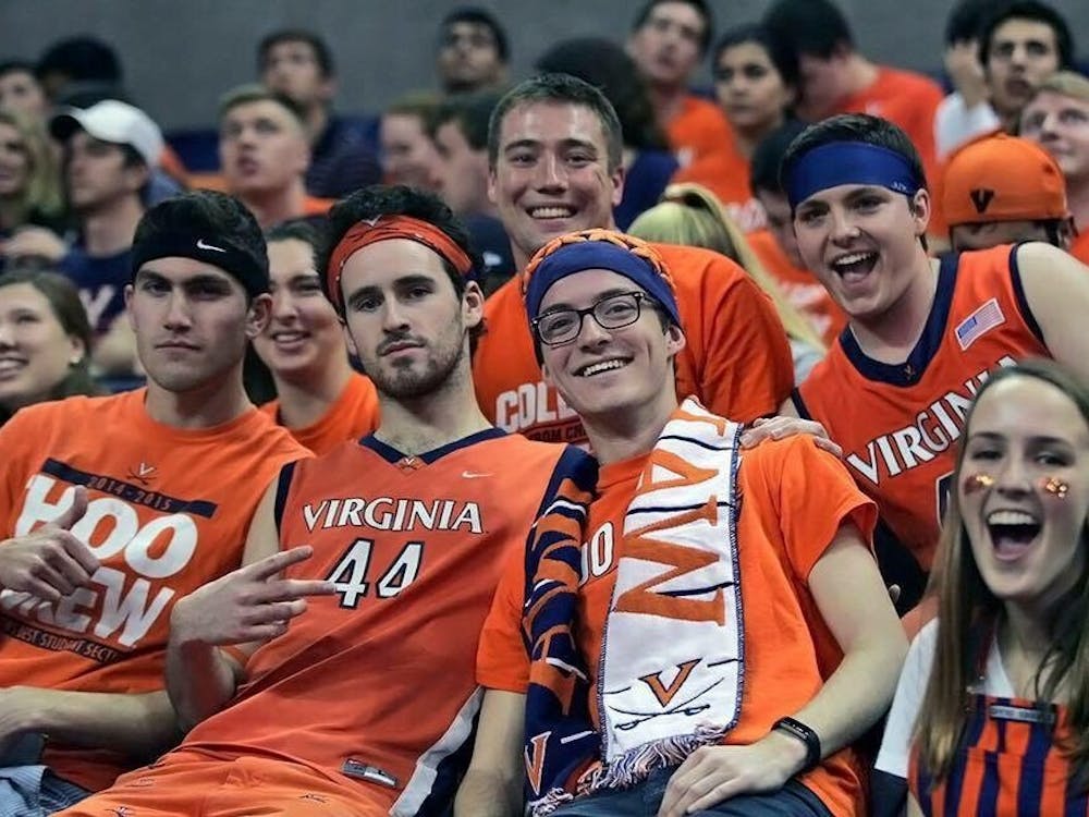 Dustin Jones (pictured second from left) sports his traditional gameday outfit with other Hoo Crew members.