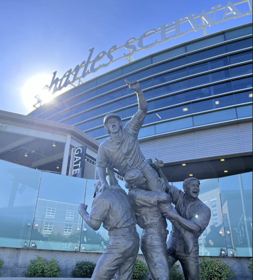 Brian O'Connor is immortalized outside Charles Schwab Field, celebrating with Creighton teammates.