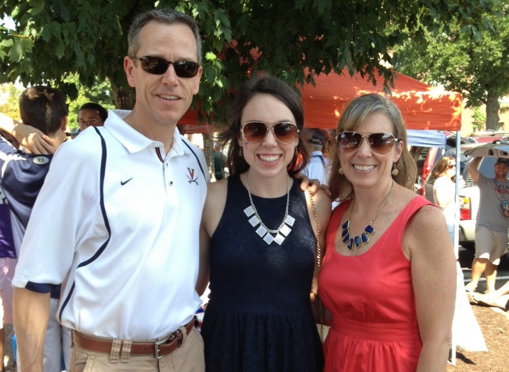 	Rivas (middle) with her parents, tailgating before Virginia&#8217;s Sept. 7 matchup against Oregon.