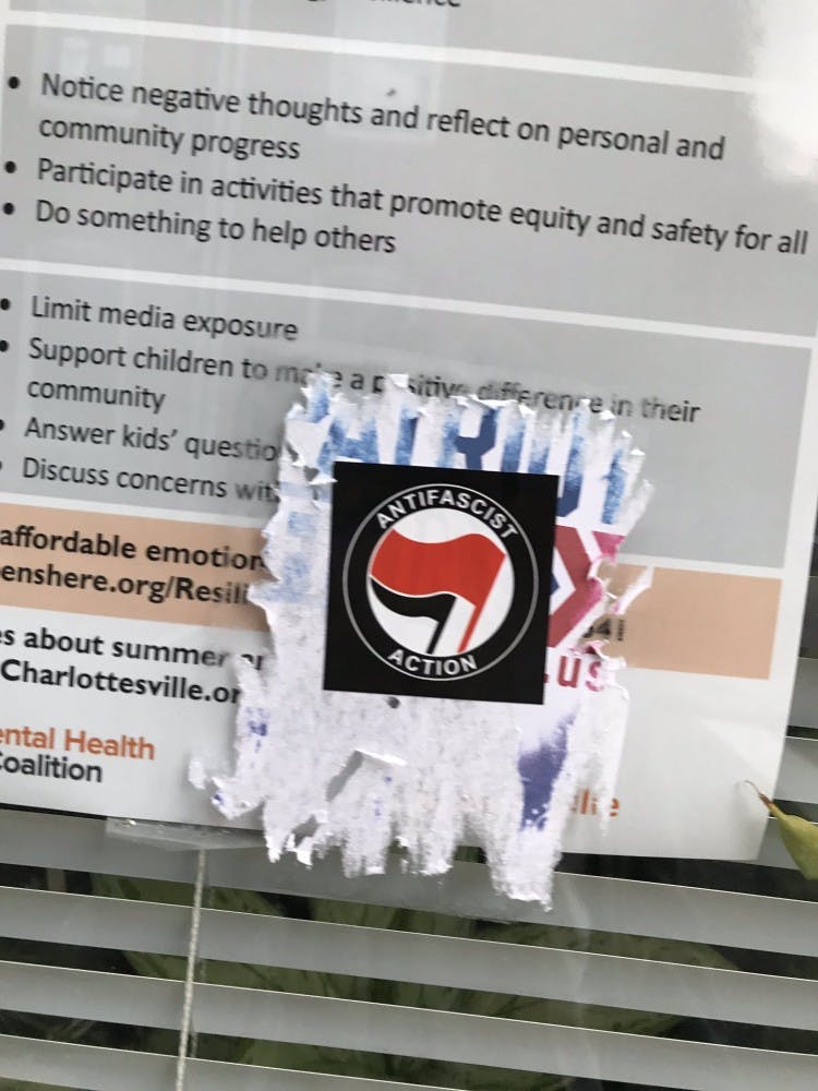 As of Monday evening, the flyers around Heather Heyer Way had been destroyed and replaced with anti-fascist stickers.