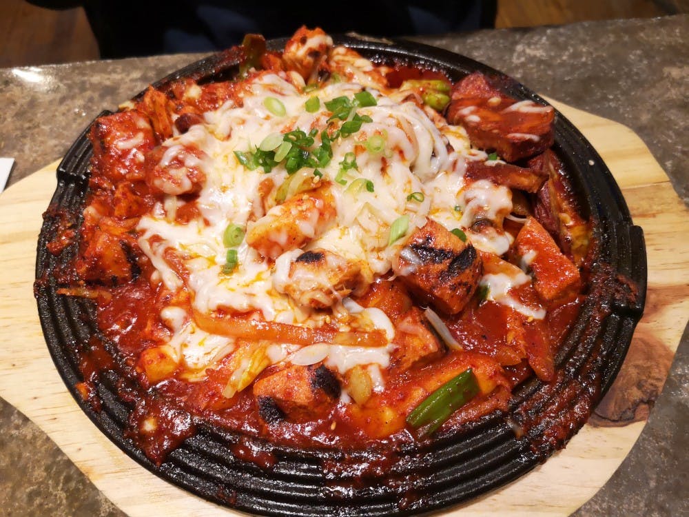 <p>Budae Jjigae — also called “Korean Army Stew" — is a hot stew with ham, sausages, ramen noodles and vegetables and is topped with Kimchi sauce and cheese.&nbsp;</p>