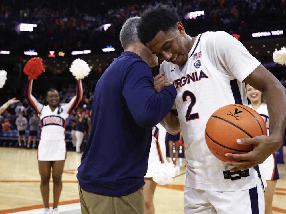 Reece Beekman and Coach Tony Bennett embrace on Senior Day, Beekman’s final game at John Paul Jones Arena.