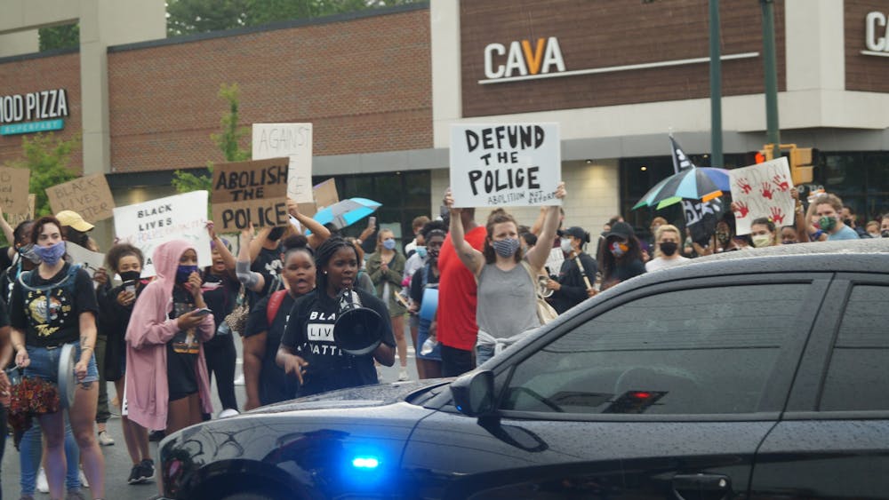 Students and community called to defund the police at a block party organized by rising second-year College student Zyahna Bryant and Trinity Hughes outside of John Paul Jones Arena June 13.
