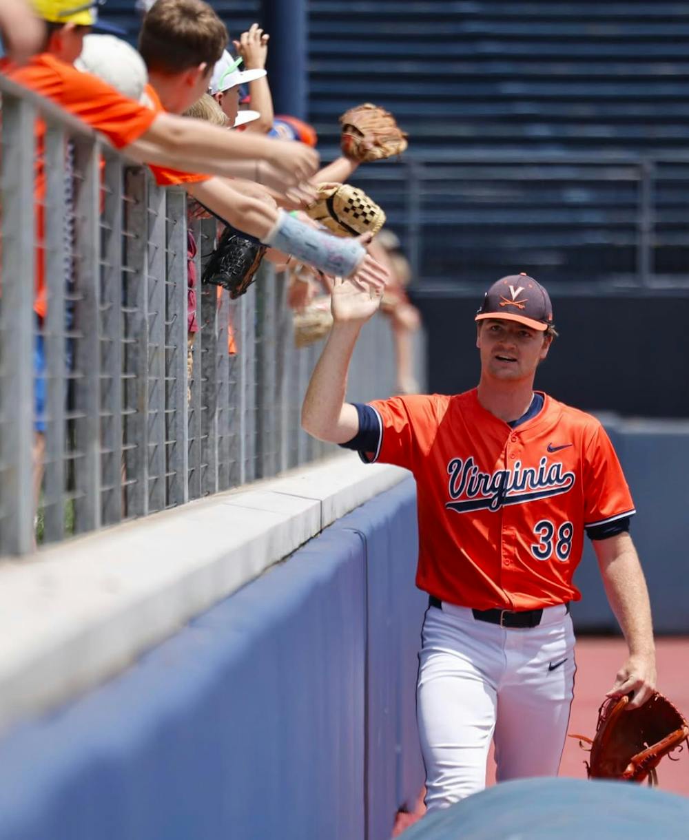 Kampschror high-fives Virginia fans at Disharoon Park.