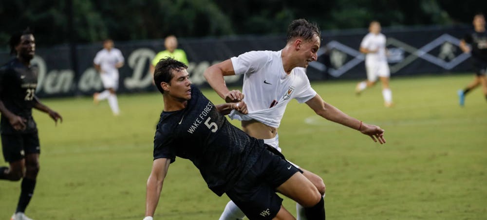 <p>Freshman forward Joaquín Brizuela battles for the ball with a Wake Forest defender.</p>