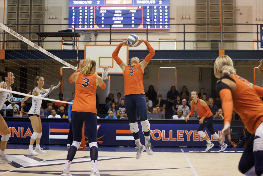 <p>Senior setter Ashley Le leaps to set the ball against Coastal Carolina.</p>