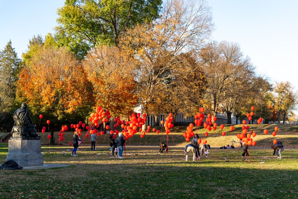 The installation featured red balloons tied to flyers on the ground which displayed the photo and name of each hostage.&nbsp;
