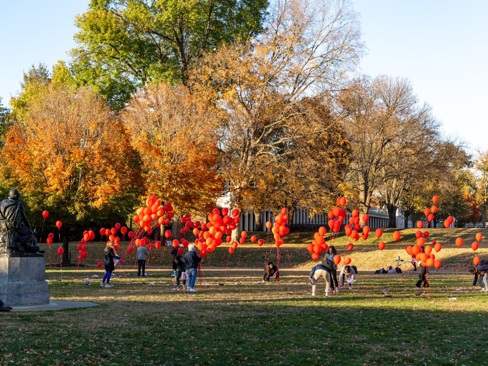 The installation featured red balloons tied to flyers on the ground which displayed the photo and name of each hostage.&nbsp;