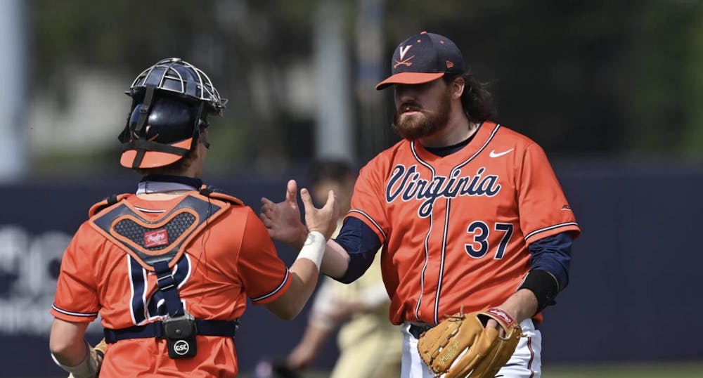 <p>Virginia's Stephen Schoch walks off the mound after closing out the win.</p>