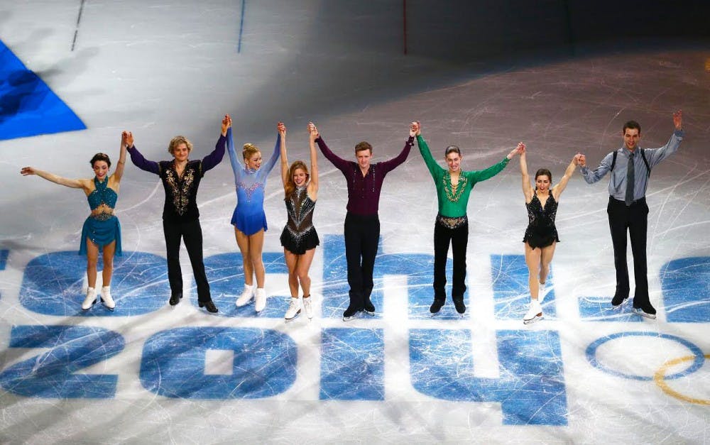 SOCHI, RUSSIA - FEBRUARY 09:  Bronze medalists the United States figure skating team (L-R) Meryl Davis, Charlie White, Gracie Gold, Ashley Wagner, Jeremy Abbott, Jason Brown, Maria Castelli and Simon Shnapir celebrate during the flower ceremony for the Team Figure Skating Overall during day two of the Sochi 2014 Winter Olympics at Iceberg Skating Palace onon February 9, 2014 in Sochi, Russia.  (Photo by Clive Mason/Getty Images)