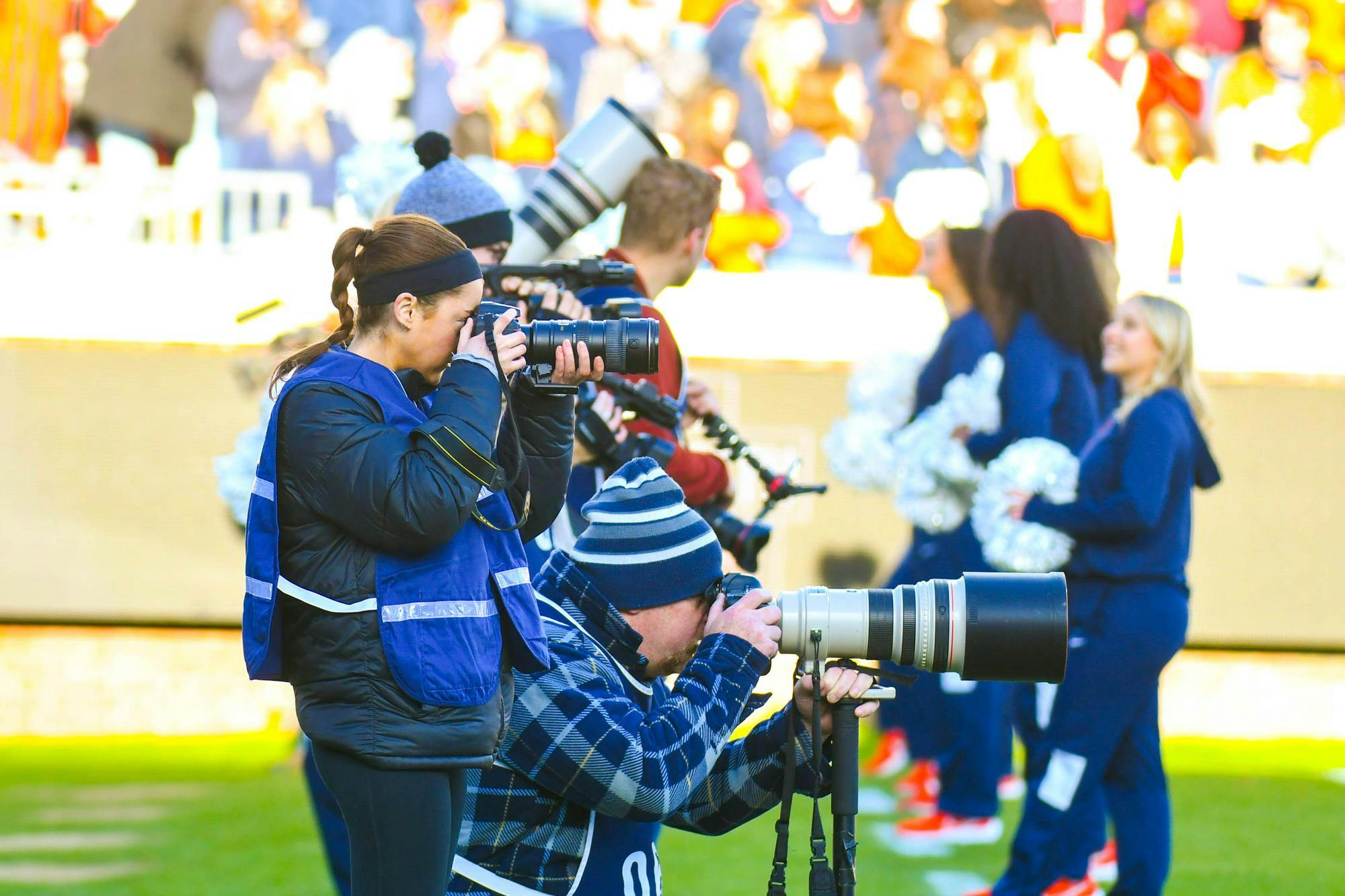 Ava MacBlane, the 134th Editor-in-Chief of The Cavalier Daily, captures a photograph at Scott Stadium.