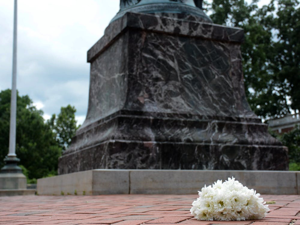 Flowers at the base of the Jefferson Statue, where students counter-protestors met a group of white supremacists Aug. 11, 2017.&nbsp;
