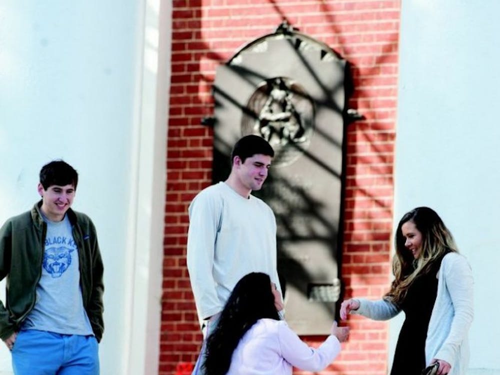 	In a double-date Love Connection, junior guard Joe Harris and his friend Hart meet their dates on the steps of the Rotunda before heading to Basil for dinner.