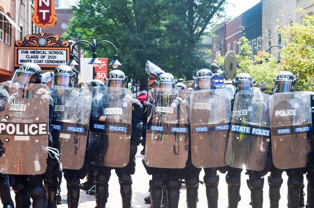 <p>Police form a defensive line on the Downtown Mall during last August's Unite the Right rally.&nbsp;</p>