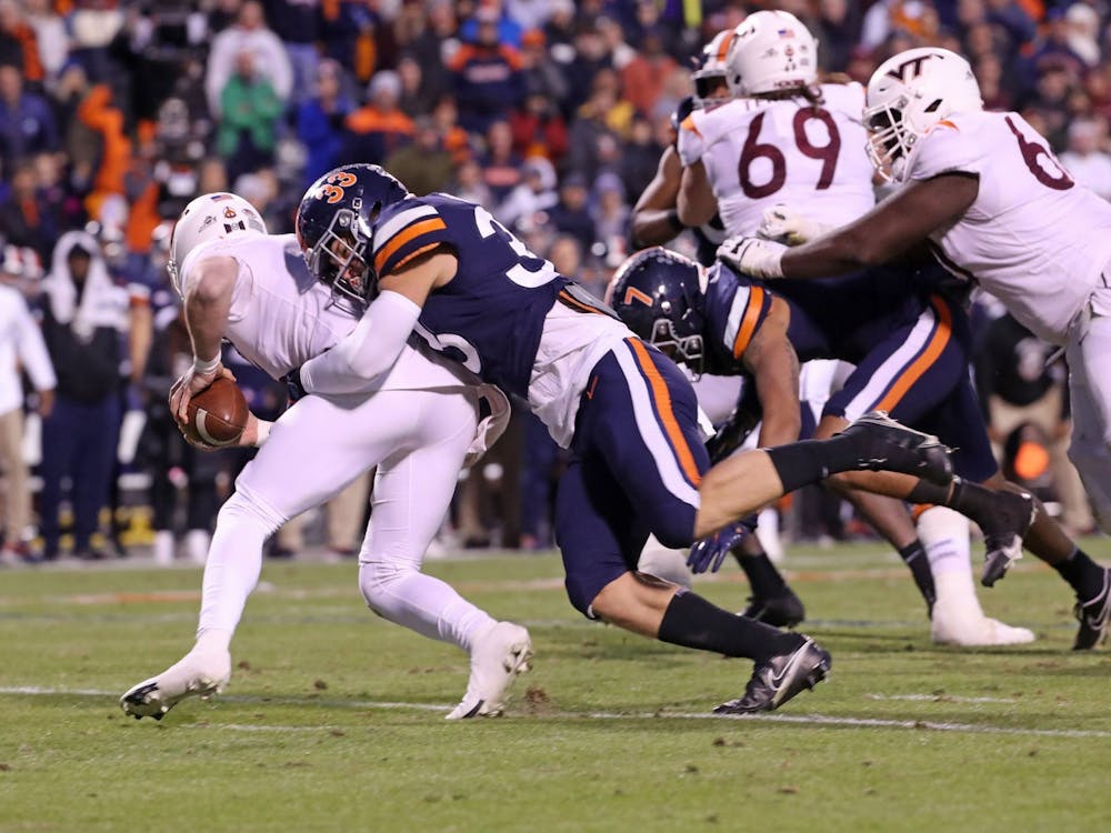 Virginia freshman inside linebacker West Weeks sacks Virginia Tech junior quarterback Braxton Burmeister during the second quarter Saturday. Weeks committed a roughing-the-punter penalty a play later.