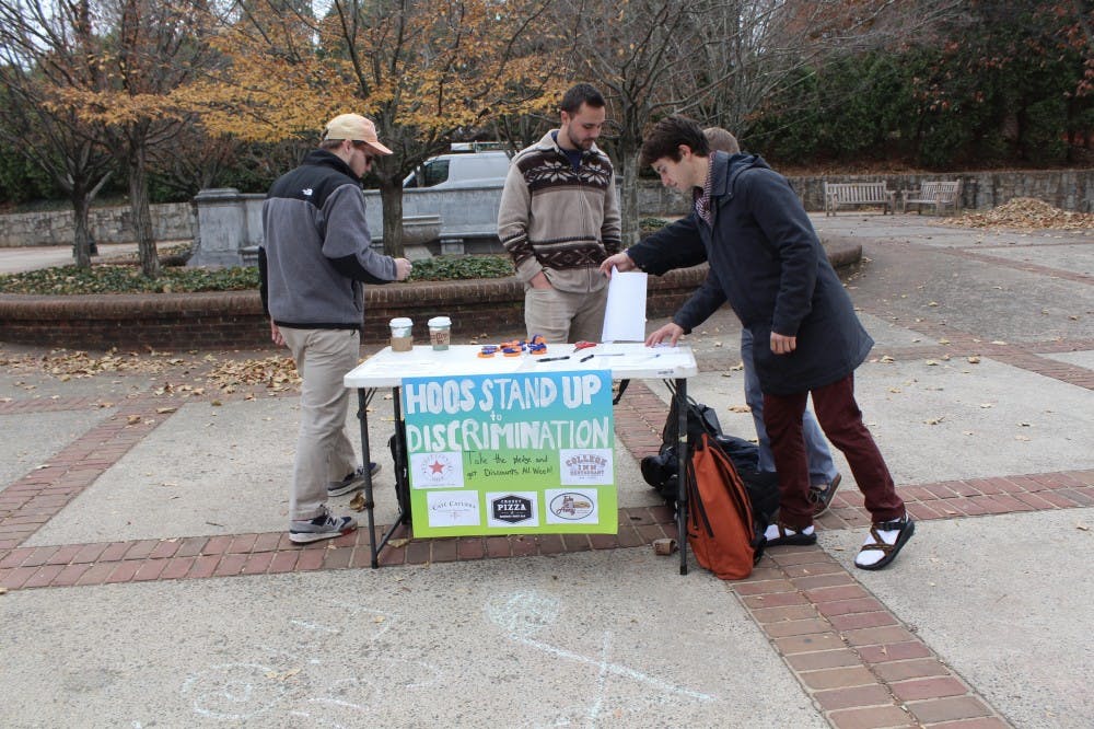 Sigma Pi brothers tabling for their anti-discrimination campaign.