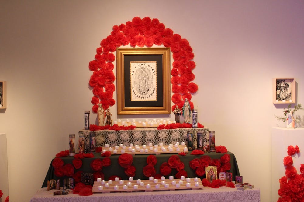 <p>The focal point of the exhibit was a large altar along the left wall, under a piece entitled “Our Lady of Guadalupe.”</p>