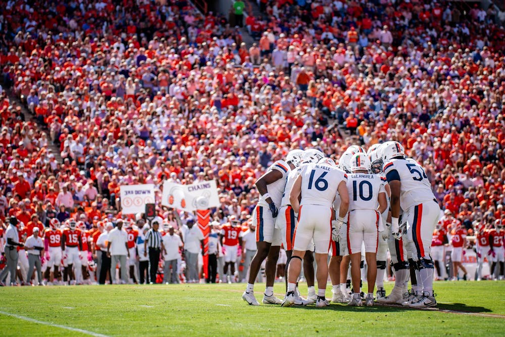 Virginia's offense huddles, surrounded by legions of Clemson fans.